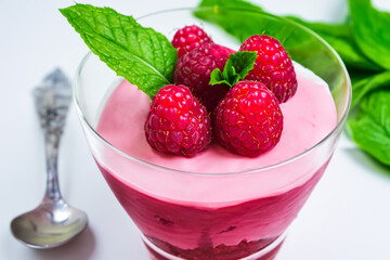 Leaf of raspberry and mint in pudding. food dessert sweet concept. a bowl of white pudding with...