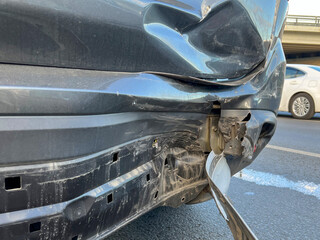 Damaged car bumper after car accident close up