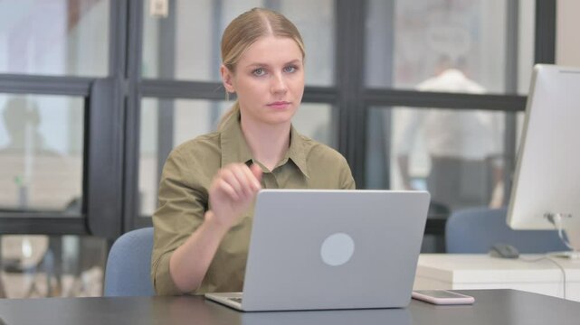 Young Businesswoman in Denial Looking at Camera while at ork