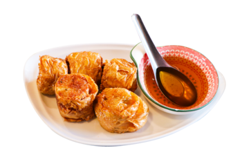 Hoi jo crab rolls or crab jujube places With delicious plum sauce and spoon on white tiled dish isolated on cut out PNG or transparent background. Thai people called Hoi-cho local traditional style.