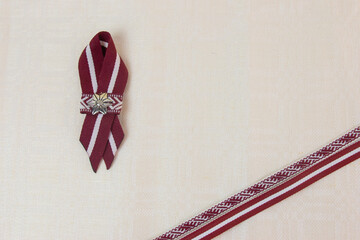 red and white ribbon, symbol of independence day, on linen fabric, symbol of the day of the proclamation of the republic, independence of the republic with space for text
