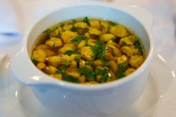 bowl of traditional polish soup - chicken broth (rosol) with noodles