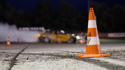 Race car drifting around the road cones on race track at night © Video_StockOrg