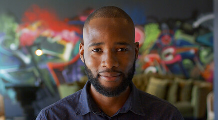 Portrait Of Mid Adult Man Urban Setting With Graffiti Covered Wall Behind