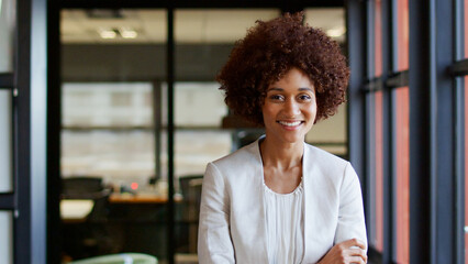 Portrait Of Smiling Young Businesswoman Working In Modern Open Plan Office © Monkey Business