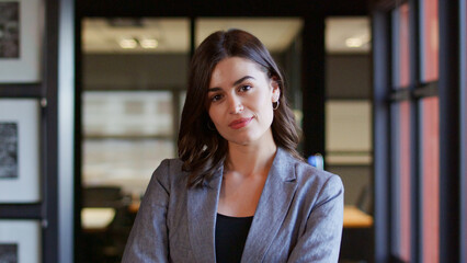 Portrait Of Serious Young Businesswoman Working In Modern Open Plan Office