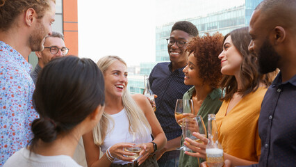 Multi-Cultural Business Team Meeting Outdoors For After Work Drinks On Office Rooftop Or Bar