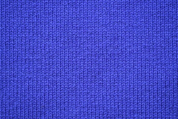 Macro texture of purple wool crochet sweater as background, close-up of purple crochet front surface, texture of woolen wool, crochet front surface