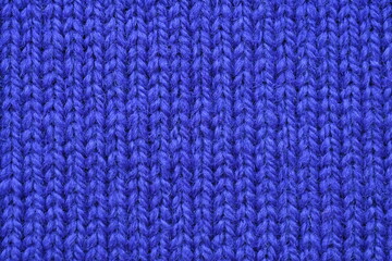 Macro texture of purple wool crochet sweater as background, close-up of purple crochet front surface, texture of woolen wool, crochet front surface