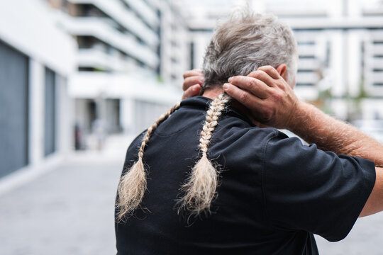 Mature man after donating his long braided hair