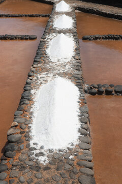 Rows of salt heaps in traditional salt pans