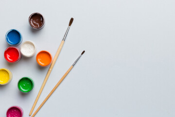 art palette with paint and brushes, close up. Top view with empty space. workplace for creativity. home teaching concept drawing