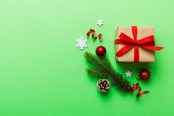 Top view Flat lay Christmas decorations and gift box on colored background with copy space. Christmas or Happy New Year composition