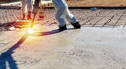 builder pouring concrete with a concrete pump