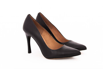 Pair of women's black leather court shoes on a white background
