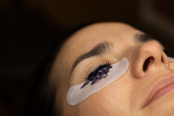 makeup artist doing eyelash lamination for a client