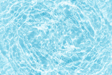 Blue water with ripples on the surface. Defocus blurred transparent blue colored clear calm water surface texture with splashes and bubbles. Water waves with shining pattern texture background.