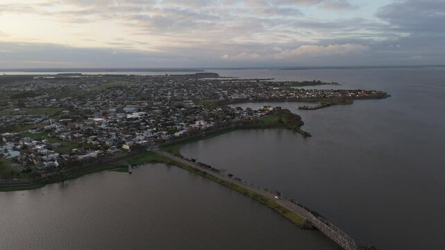 Drone footage capturing the panoramic view of federacion city in entre rios province, argentina, showcasing uruguay river coast , salto grande lake, and the bridge