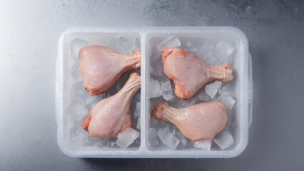 A portion of chicken drumsticks, neatly packed in an ice container. Ideal for use in recipes and culinary projects. A fresh and high-quality product for a healthy diet