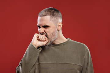 angry man biting his hand