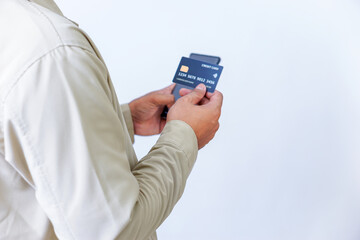 A person holding credit cards and a phone, ready for a transaction or payment.