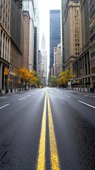 Empty city street with yellow lines and autumn trees, urban landscape.