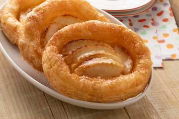 Plate with fresh homemade puff pastry apple biscuit close up