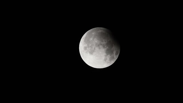 Celestial Event &ndash; Partial Full Moon Eclipse Video - Telescope view of partial lunar eclipse with sharp craters and valleys on full moon
