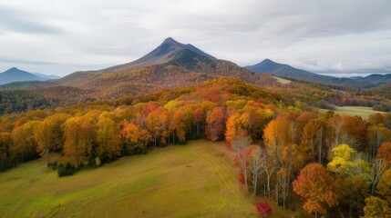 Obraz premium Majestic Mountain Vista in Vibrant Fall Colors, showcasing the breathtaking beauty of nature on the first day of autumn, a stunning display of seasonal transformation.