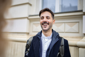 Close up portrait of smiling man at the street, urban portrait