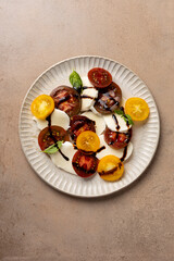 Caprese salad with sliced heirloom tomatoes and cheese  top view