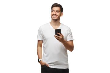 Young man standing in white t-shirt holding smartphone in hand and looking away with dreamful smile