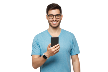 Young handsome man in blue t-shirt holding smartphone and looking at camera with smile while standing isolated on gray background