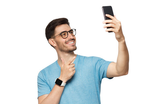 Young man in blue t-shirt with smartwatch on wrist, holding phone up and taking selfie portrait - Powered by Adobe
