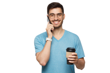 Portrait of young handsome male in blue t-shirt and glasses, holding takeaway coffee cup and talking on phone
