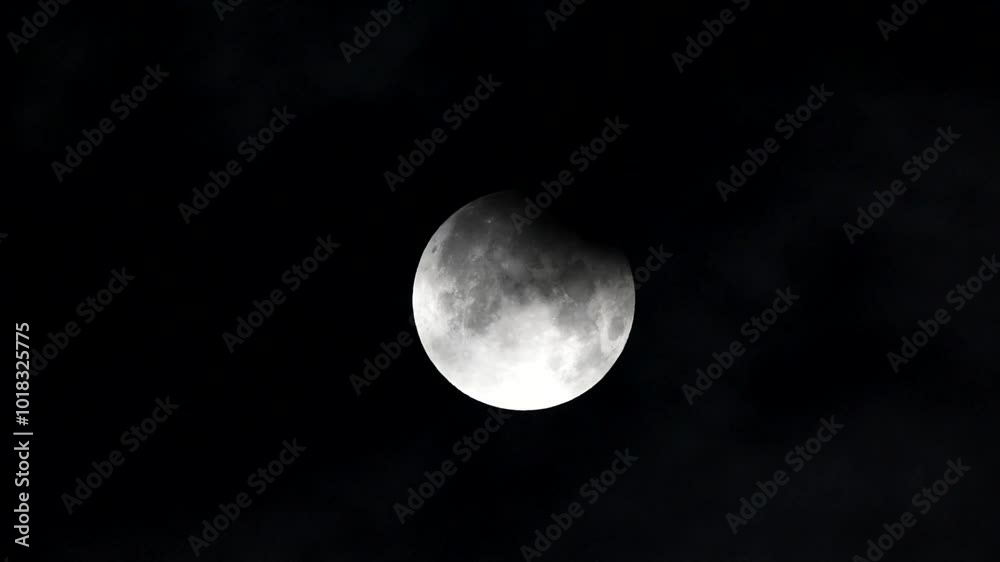 Wall mural partial lunar eclipse full moon and lunar eclipse full moon between the clouds super moon 2024