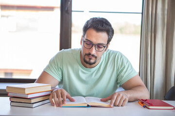 Fototapeta premium Young handsome man studying online at home. Distance education concept 