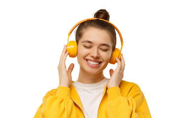 Young woman listening to music via wireless headphones with eyes closed