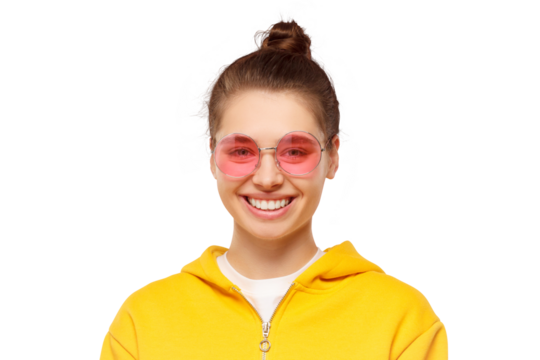 Close-up portrait of young smiling girl wearing yellow casual hoodie and round colored glasses