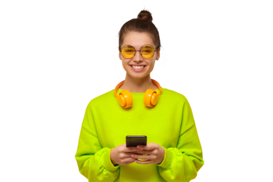 Young teenage girl in neon green sweatshirt and glasses, holding smartphone in hands, using app or going to text friends