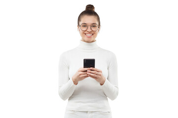 Young woman holding phone in hands, smiling happily at camera