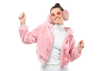 Young dancing woman wearing pink trendy fluffy bomber, ear warmers or winter headphones and trendy glasses