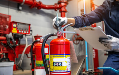 Engineer are checking and inspection a fire extinguishers tank in the fire control room for safety...