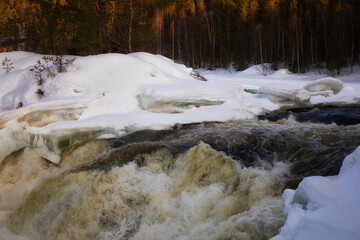 Winter landscape with a waterfall and snow. Russia, Karelia
