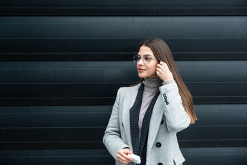 Portrait of young businesswoman standing outside office building. Successful professional office...