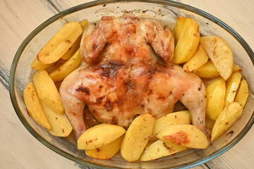 baked potatoes with roasted chicken photo from above, cinnamon crispy crust of roasted chicken and potatoes, baked dinner 
