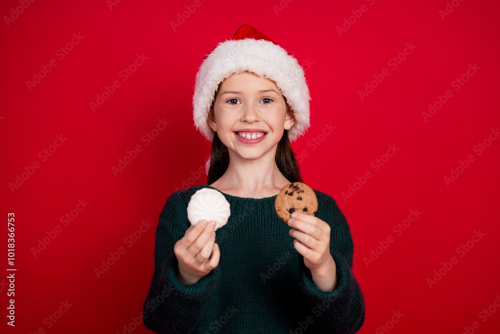 Sticker Photo portrait of cute little girl hold tasty snacks dressed green christmas clothes theme party on red color background