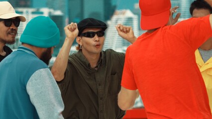 Closeup of street dancer wear colorful outfit while dance together. Group of attractive hipster dance and move to hip-hop music at skyscraper and city view. Break dance. Outdoor sport 2024. Hiphop.