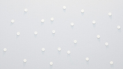 Paper surface with numerous small, round white polka dots, creating a delicate pattern that evokes the serene feel of falling snow.