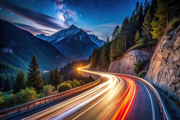 Nighttime mountain road with long exposure light trails